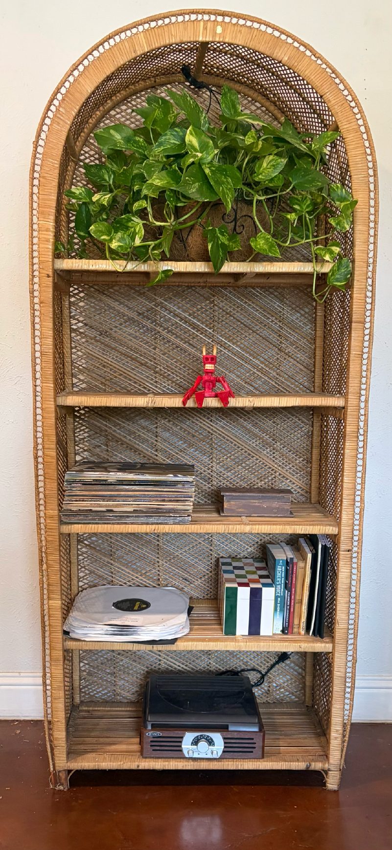 Arched rattan shelf with plants